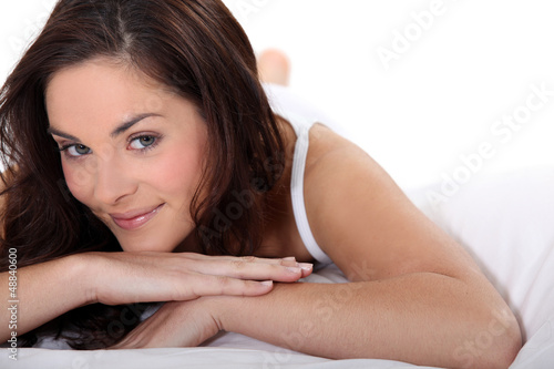 Photo: Smiling woman on a bed Smiling woman on a bed