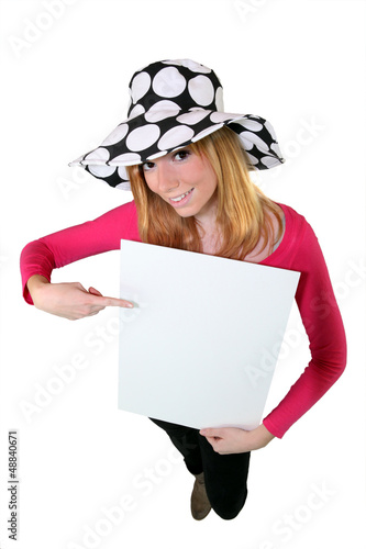 Photo: Young woman with a hat and a panel for message Young woman with a hat and a panel for message