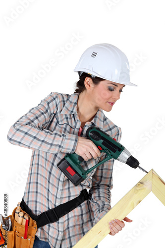 Photo: Woman constructing wooden frame Woman constructing wooden frame