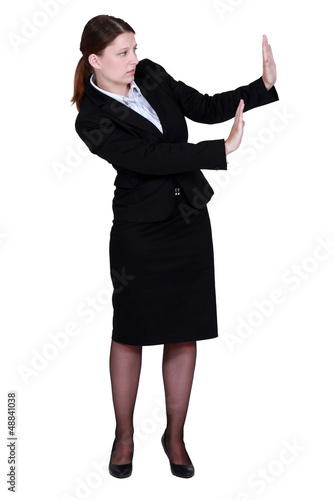 Photo: woman in a suit trying to protect herself with her hands woman in a suit trying to protect herself with her hands