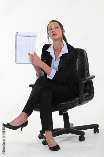Photo: Businesswoman pointing to a list Businesswoman pointing to a list