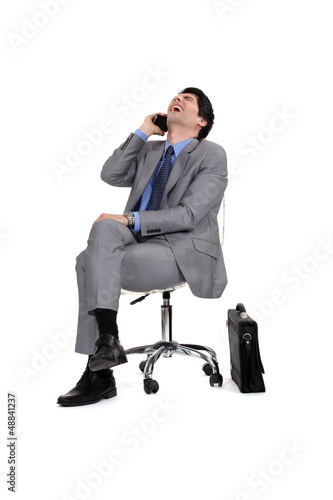 Photo: Businessman sitting and laughing Businessman sitting and laughing