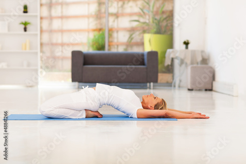 Photo: mature lady doing yoga at home mature lady doing yoga at home