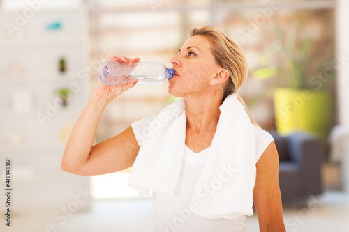 Photo: fitness mature woman drinking water after exercise fitness mature woman drinking water after exercise