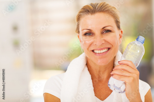 Photo: healthy senior woman with exercise towel and water healthy senior woman with exercise towel and water