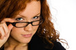 Flirting woman looking over her glasses