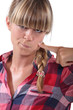 Blond woman touching her face