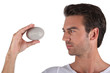 Man holding pebble in hand