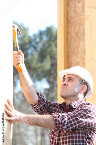 Photo: woodworker on a construction site woodworker on a construction site