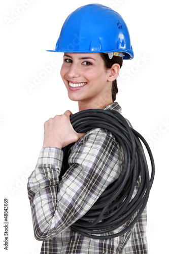 Photo: A female electrician. A female electrician.