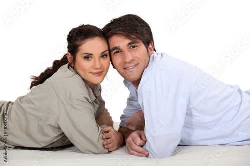 Photo: Couple laying on their fronts Couple laying on their fronts