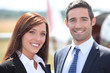 Couple in front of airplane
