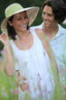 Couple relaxing in field