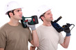 Men holding power tools