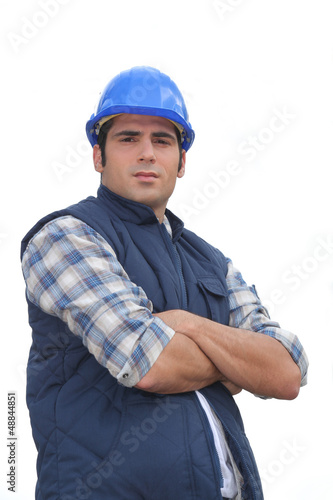 Photo: Portrait of a standoffish tradesman with his arms crossed Portrait of a standoffish tradesman with his arms crossed