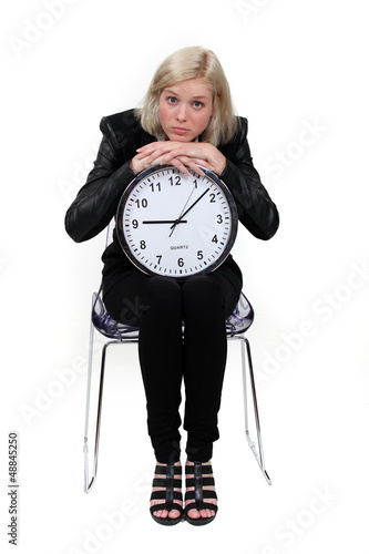 Photo: woman holding a huge clock woman holding a huge clock