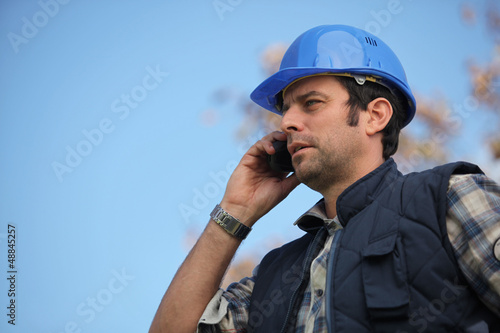 Photo: Foreman talking on his mobile phone Foreman talking on his mobile phone