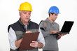 Builder stood with young apprentice