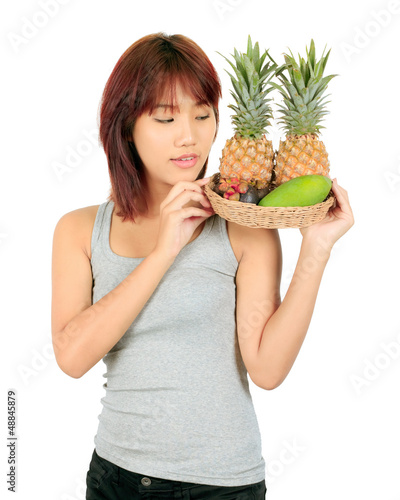 Photo: Isolated young asian woman with variety of oriental fruits. Isolated young asian woman with variety of oriental fruits.