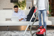 Woman vacuuming in the apartment