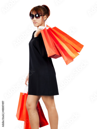 Photo: Isolated young asian woman carries shopping bags Isolated young asian woman carries shopping bags