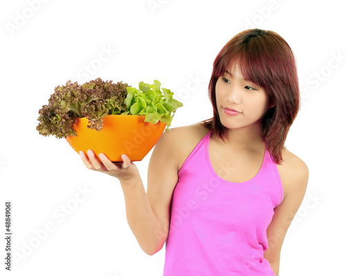 Photo: Isolated young asian woman with ca bowl of various vetgetables Isolated young asian woman with ca bowl of various vetgetables