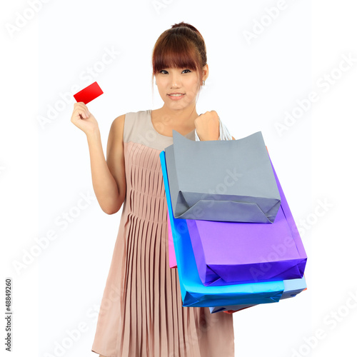 Photo: Isolated Yong Asian Woman With colorful Shopping Bags Isolated Yong Asian Woman With colorful Shopping Bags