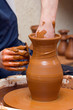 potter makes a jug out of clay