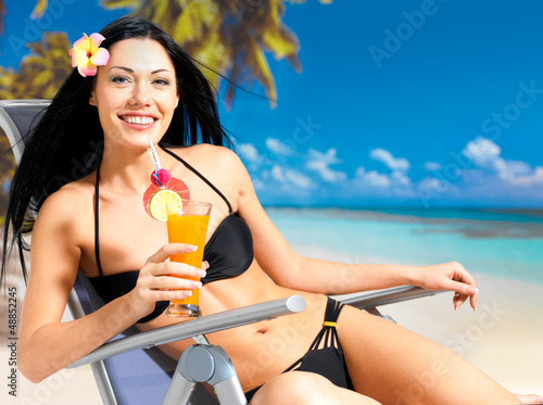 Photo: Happy woman on vacation enjoying at beach Happy woman on vacation enjoying at beach