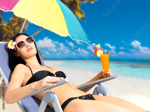 Photo: woman on vacation enjoying at beach woman on vacation enjoying at beach
