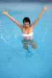 Brunette jumping in swimming pool