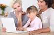 Foto: Parents with daughter and computer Parents with daughter and computer