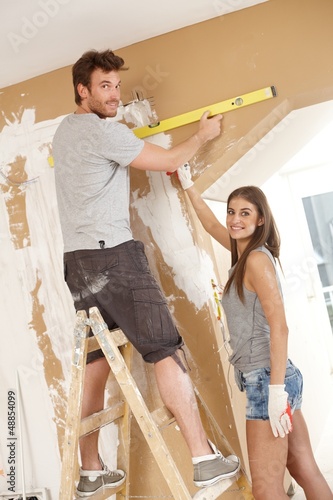 Photo: Young couple building new home Young couple building new home