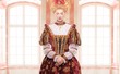 Her royal highness standing against window