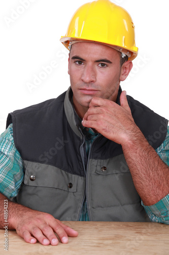 Photo: Pensive manual worker Pensive manual worker