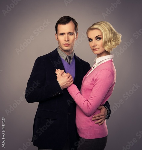 Photo: Elegant couple isolated on grey background Elegant couple isolated on grey background
