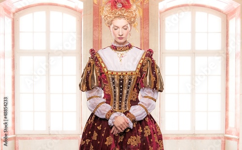 Photo: Her royal highness standing against window Her royal highness standing against window