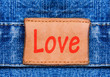 Closeup jeans leather label with text Love