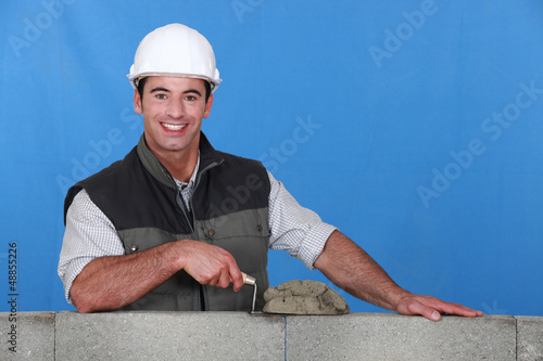 Photo: Man laying bricks Man laying bricks