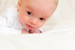 Cute newborn baby lying in bed