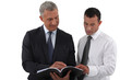 Two businessmen reading document