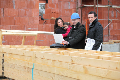 Photo: Architect showing plans to customer Architect showing plans to customer