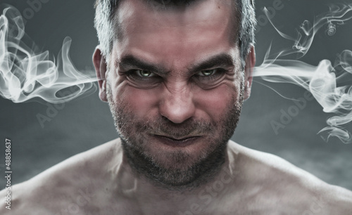Photo: Close up of angry man with steam coming out from his ears Close up of angry man with steam coming out from his ears
