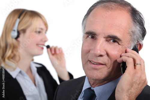 Photo: Senior executive with female assistant Senior executive with female assistant