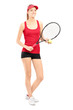 Full length portrait of a smiling female holding a tennis racket