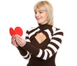 Photo: Happy mature woman reading heart shaped postcard Happy mature woman reading heart shaped postcard