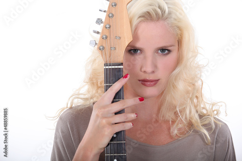 Photo: Woman holding an electric guitar Woman holding an electric guitar