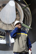 airplane mechanic with giant jumbo jet engine