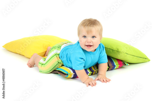 Photo: Little boy and color pillows, isolated on white Little boy and color pillows, isolated on white