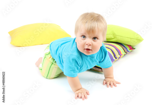 Photo: Little boy and color pillows, isolated on white Little boy and color pillows, isolated on white